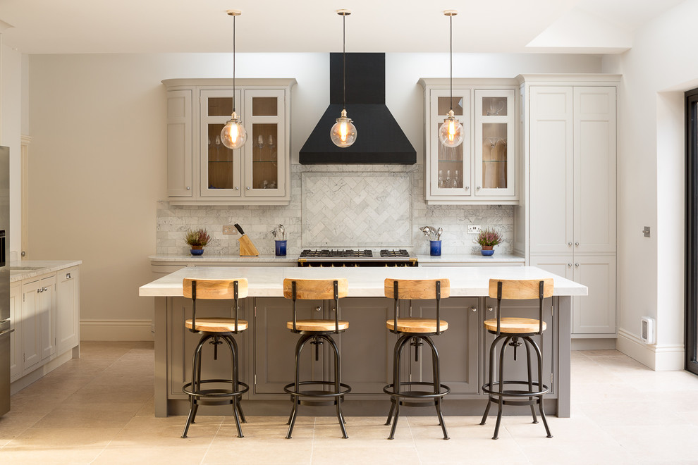 Inspiration for a large transitional l-shaped porcelain tile eat-in kitchen remodel in London with shaker cabinets, gray cabinets, an island and ceramic backsplash