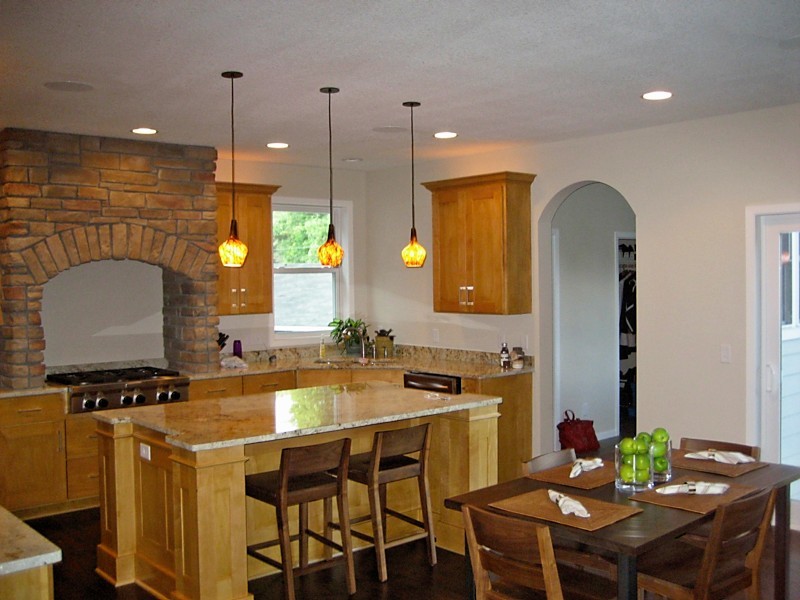Eat-in kitchen - large traditional u-shaped dark wood floor eat-in kitchen idea in Minneapolis with a drop-in sink, flat-panel cabinets, medium tone wood cabinets, granite countertops, stainless steel appliances and an island
