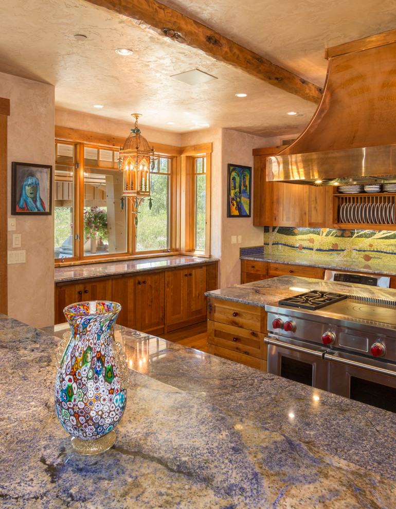 This is an example of an expansive traditional kitchen/diner in Denver with a submerged sink, recessed-panel cabinets, medium wood cabinets, granite worktops, blue splashback, mosaic tiled splashback, stainless steel appliances, medium hardwood flooring and an island.
