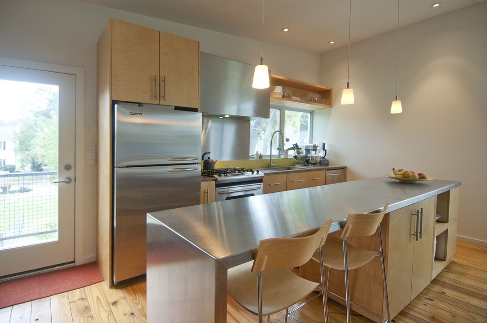 This is an example of a contemporary kitchen in Houston with stainless steel worktops.