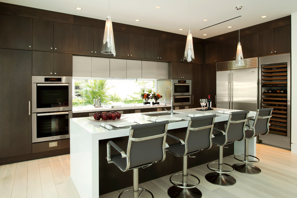 Mid-sized trendy l-shaped light wood floor eat-in kitchen photo in Miami with an undermount sink, flat-panel cabinets, dark wood cabinets, quartz countertops, stainless steel appliances and an island