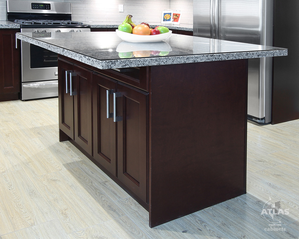 Example of a mid-sized trendy u-shaped light wood floor eat-in kitchen design in Vancouver with an undermount sink, dark wood cabinets, an island, recessed-panel cabinets, granite countertops, beige backsplash, ceramic backsplash and stainless steel appliances