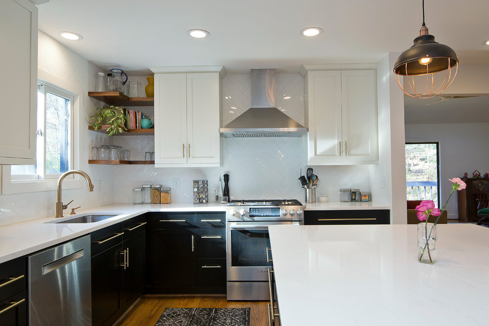 Mid-sized urban l-shaped medium tone wood floor and orange floor eat-in kitchen photo in Raleigh with a single-bowl sink, shaker cabinets, black cabinets, quartz countertops, white backsplash, ceramic backsplash, stainless steel appliances, an island and white countertops