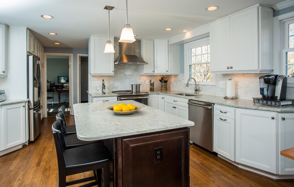 Trendy l-shaped dark wood floor open concept kitchen photo in DC Metro with a double-bowl sink, recessed-panel cabinets, white cabinets, granite countertops, beige backsplash, stone tile backsplash, stainless steel appliances and an island