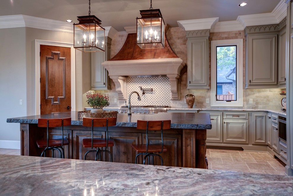 Eat-in kitchen - mid-sized transitional u-shaped travertine floor eat-in kitchen idea in Oklahoma City with raised-panel cabinets, gray cabinets, stainless steel appliances, an island, a farmhouse sink, granite countertops, beige backsplash and brick backsplash