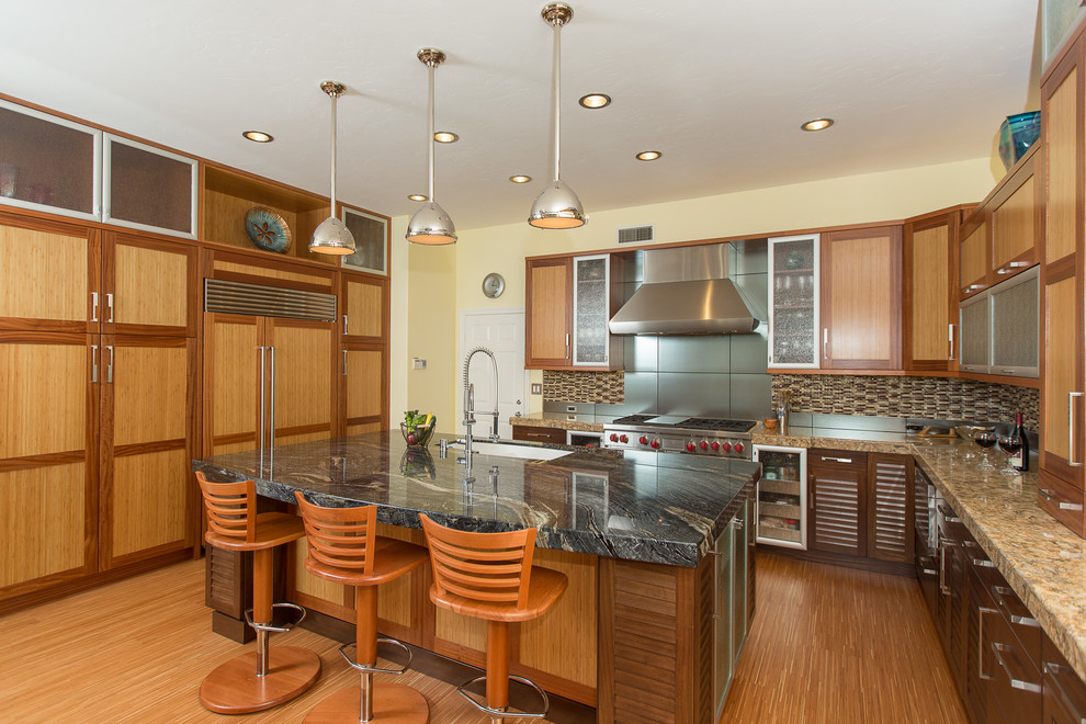 World-inspired kitchen in Orange County with shaker cabinets, medium wood cabinets, granite worktops, multi-coloured splashback, matchstick tiled splashback and stainless steel appliances.