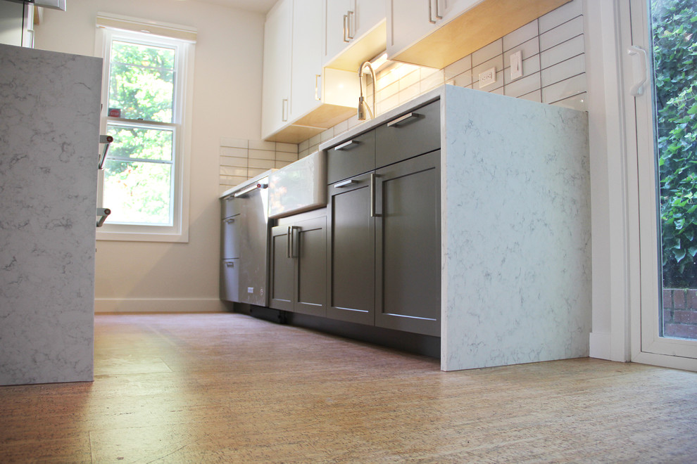 Example of a small minimalist galley medium tone wood floor and brown floor eat-in kitchen design in Portland with an undermount sink, shaker cabinets, white cabinets, marble countertops, white backsplash, subway tile backsplash, stainless steel appliances and no island