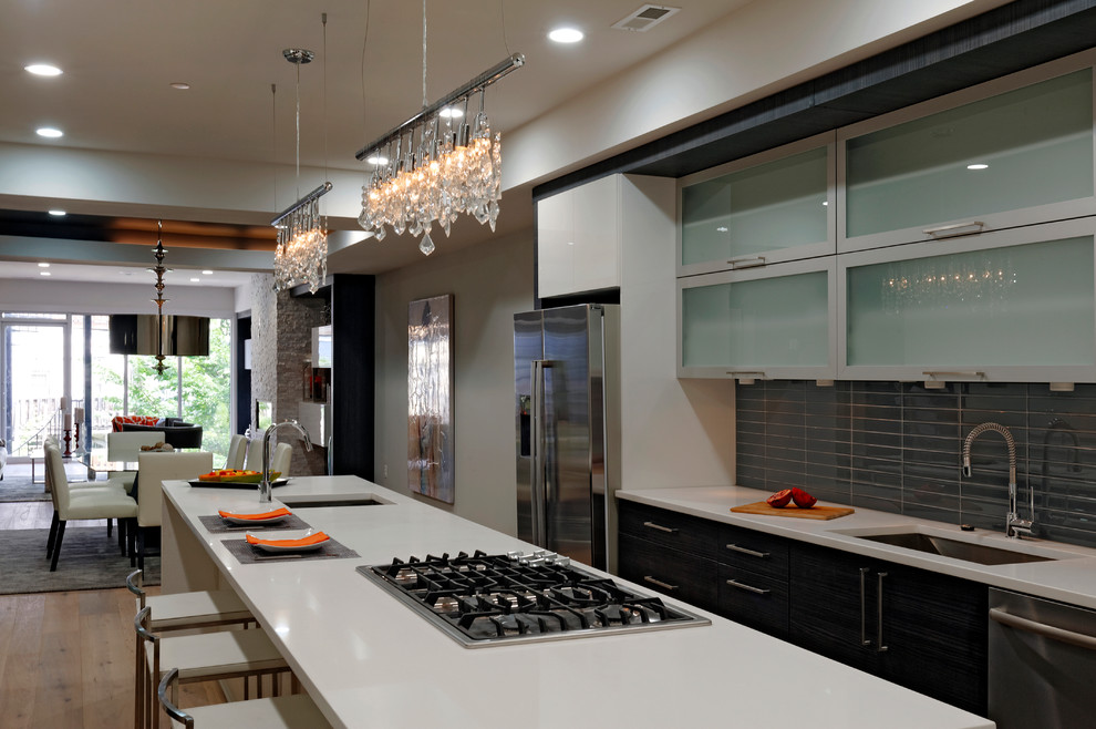 Eat-in kitchen - mid-sized contemporary galley concrete floor and beige floor eat-in kitchen idea in DC Metro with an undermount sink, flat-panel cabinets, dark wood cabinets, quartzite countertops, gray backsplash, glass tile backsplash, stainless steel appliances and an island