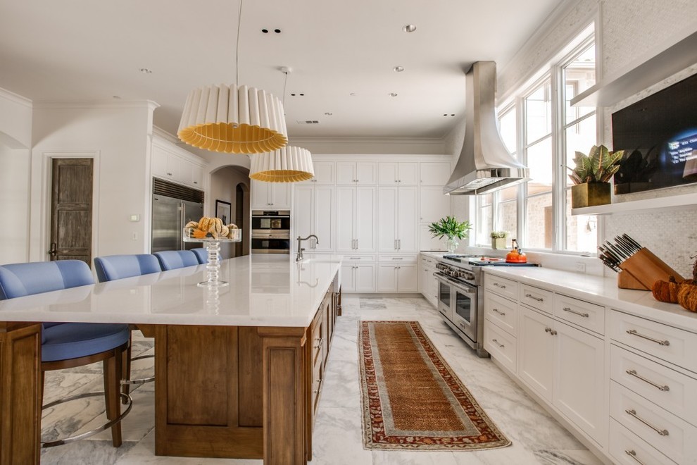 Inspiration for a large traditional galley kitchen in Dallas with a belfast sink, shaker cabinets, white cabinets, white splashback, mosaic tiled splashback, stainless steel appliances, marble flooring and an island.