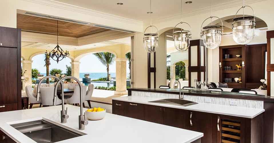 Inspiration for a large classic u-shaped open plan kitchen in Miami with a double-bowl sink, flat-panel cabinets, dark wood cabinets, engineered stone countertops, grey splashback, matchstick tiled splashback, stainless steel appliances and multiple islands.
