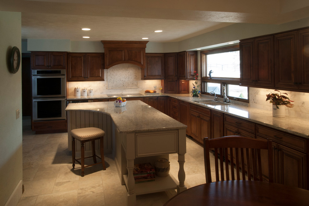 Large elegant l-shaped eat-in kitchen photo in Denver with an undermount sink, raised-panel cabinets, medium tone wood cabinets, quartzite countertops, glass tile backsplash, stainless steel appliances and an island
