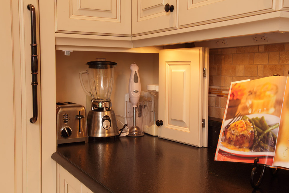 Classic kitchen in Minneapolis with black worktops.