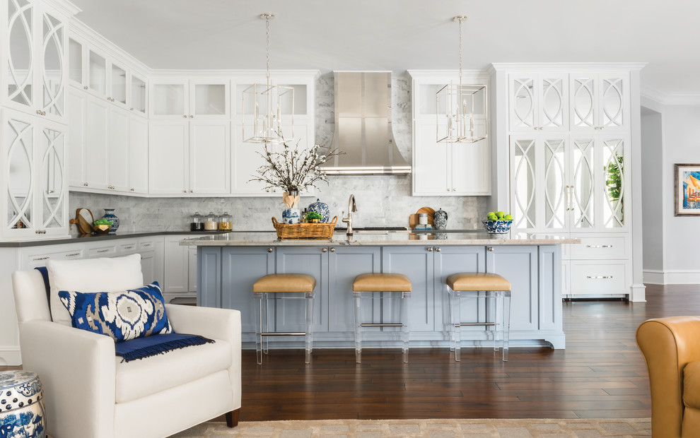 Inspiration for a large traditional l-shaped open plan kitchen in Houston with a submerged sink, recessed-panel cabinets, white cabinets, white splashback, marble splashback, dark hardwood flooring, an island, brown floors and grey worktops.