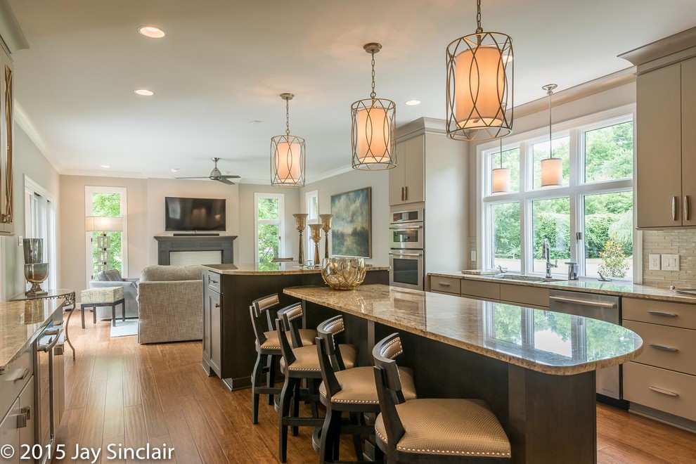 Huge transitional u-shaped medium tone wood floor eat-in kitchen photo in Other with an undermount sink, glass tile backsplash, stainless steel appliances, an island, recessed-panel cabinets, dark wood cabinets, granite countertops and beige backsplash