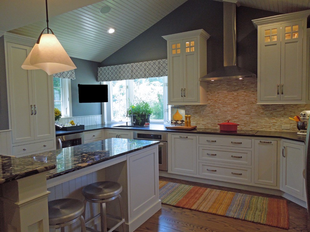 Inspiration for a timeless u-shaped medium tone wood floor eat-in kitchen remodel in Boston with an undermount sink, beaded inset cabinets, white cabinets, granite countertops, multicolored backsplash, stainless steel appliances and an island