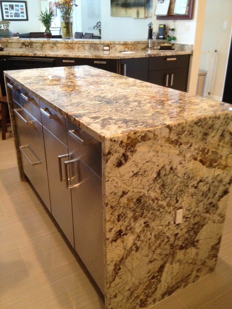Example of a large trendy u-shaped porcelain tile eat-in kitchen design in Miami with an undermount sink, flat-panel cabinets, dark wood cabinets, granite countertops, metallic backsplash, glass tile backsplash, stainless steel appliances and an island