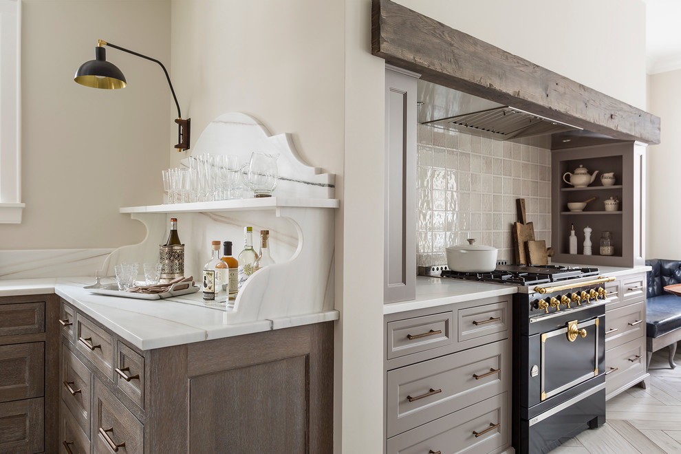 Inspiration for a large transitional porcelain tile eat-in kitchen remodel in Minneapolis with an undermount sink, recessed-panel cabinets, gray cabinets, marble countertops, gray backsplash, ceramic backsplash and black appliances