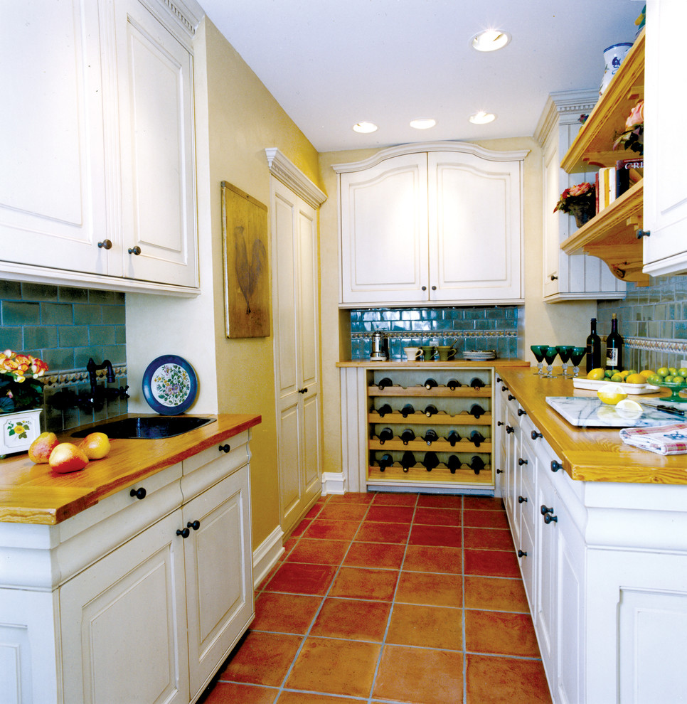 Large tuscan u-shaped terra-cotta tile kitchen pantry photo in Minneapolis with a drop-in sink, raised-panel cabinets, white cabinets, wood countertops, blue backsplash and ceramic backsplash