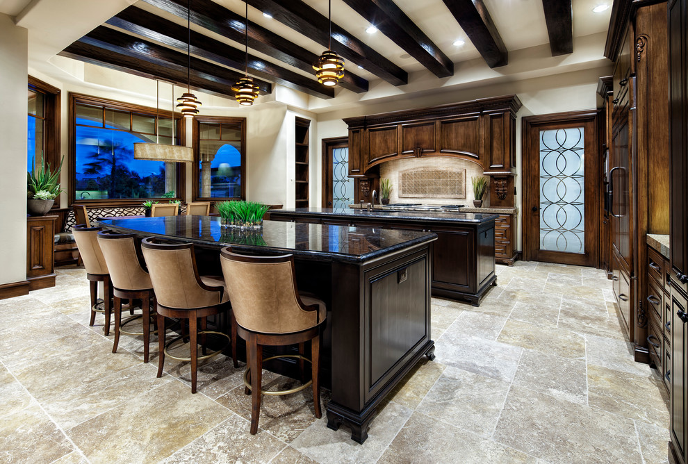 Eat-in kitchen - mediterranean eat-in kitchen idea in Houston with paneled appliances and two islands