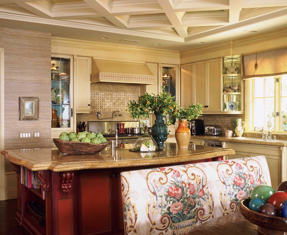 Inspiration for a french country eat-in kitchen remodel in Orange County with recessed-panel cabinets, beige cabinets and stainless steel appliances