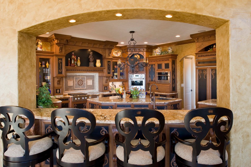 Large tuscan travertine floor eat-in kitchen photo in Indianapolis with a double-bowl sink, dark wood cabinets, granite countertops, multicolored backsplash, paneled appliances and an island