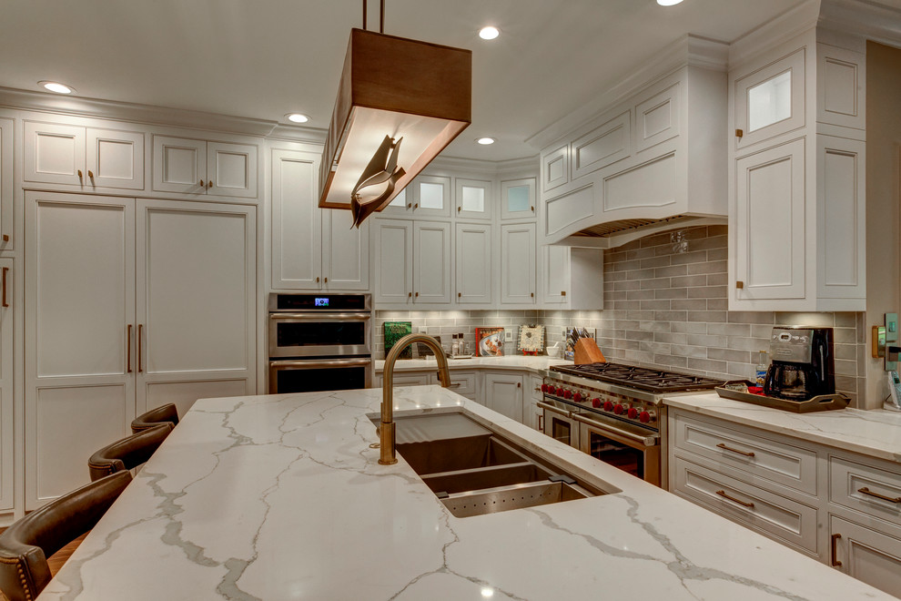 Design ideas for a large classic u-shaped open plan kitchen in Raleigh with beaded cabinets, white cabinets, grey splashback, integrated appliances, dark hardwood flooring, an island, a triple-bowl sink, marble worktops and metro tiled splashback.