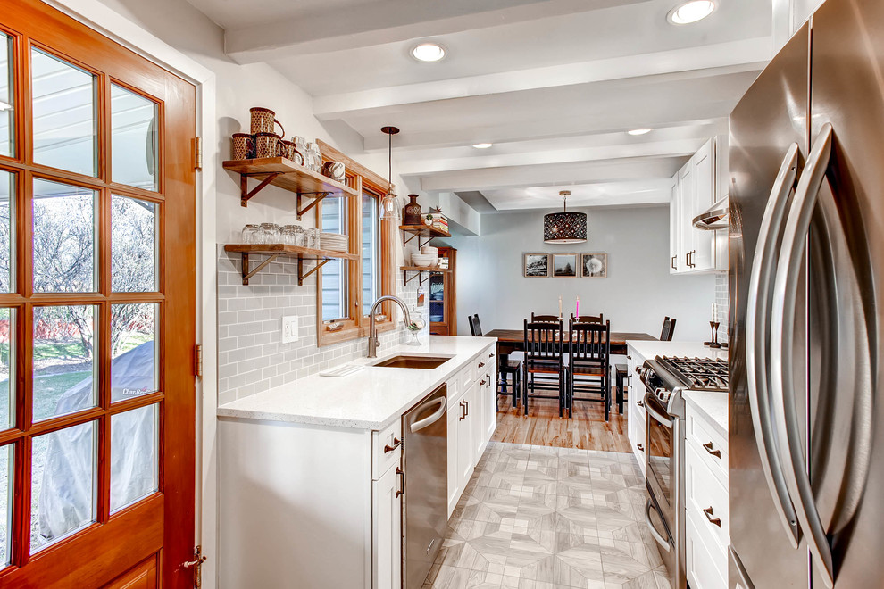 Eat-in kitchen - mid-sized country galley ceramic tile eat-in kitchen idea in Denver with a single-bowl sink, recessed-panel cabinets, white cabinets, granite countertops, gray backsplash, subway tile backsplash, stainless steel appliances and no island