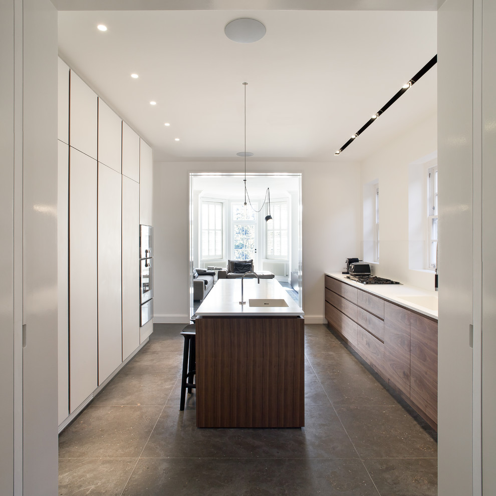 Photo of a contemporary galley open plan kitchen in London with an island.