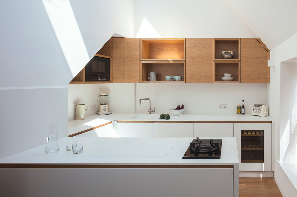 Design ideas for a contemporary u-shaped open plan kitchen in London with no island.