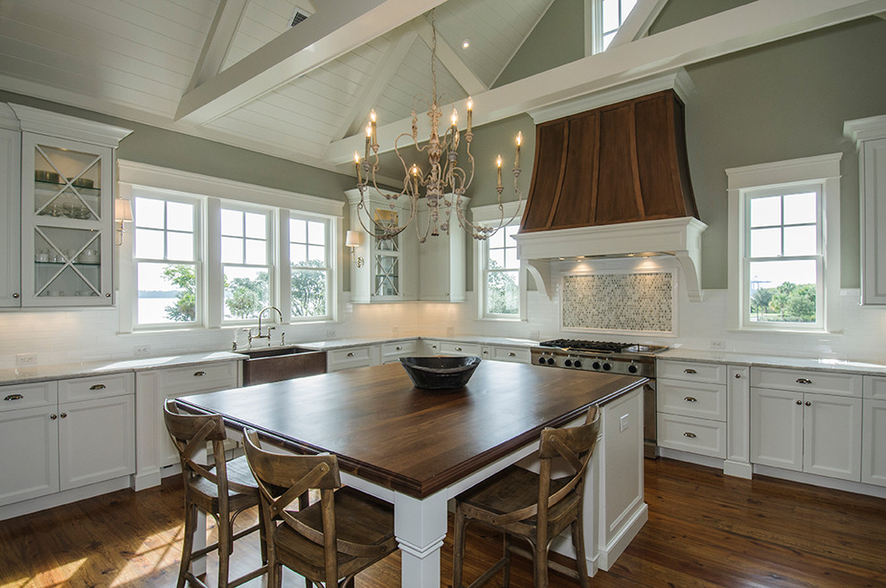 Kitchen - traditional kitchen idea in Charleston with a farmhouse sink, wood countertops, recessed-panel cabinets and white cabinets