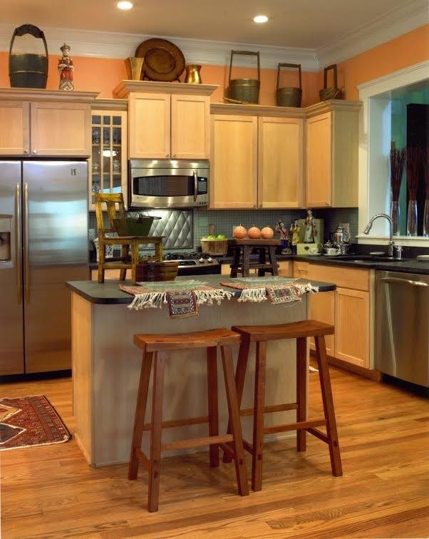 Inspiration for a medium sized world-inspired l-shaped kitchen/diner in Jacksonville with a submerged sink, stainless steel appliances, medium hardwood flooring, shaker cabinets, light wood cabinets, composite countertops, grey splashback and an island.