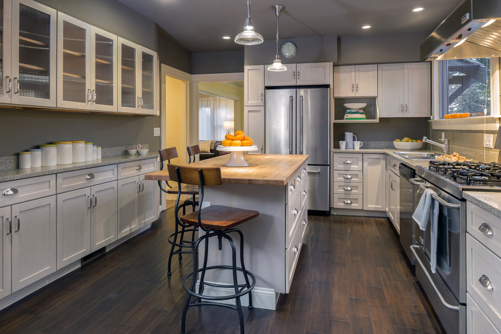 Transitional galley dark wood floor eat-in kitchen photo in San Diego with an island, shaker cabinets, white cabinets, terrazzo countertops, gray backsplash, stone slab backsplash, stainless steel appliances and a double-bowl sink