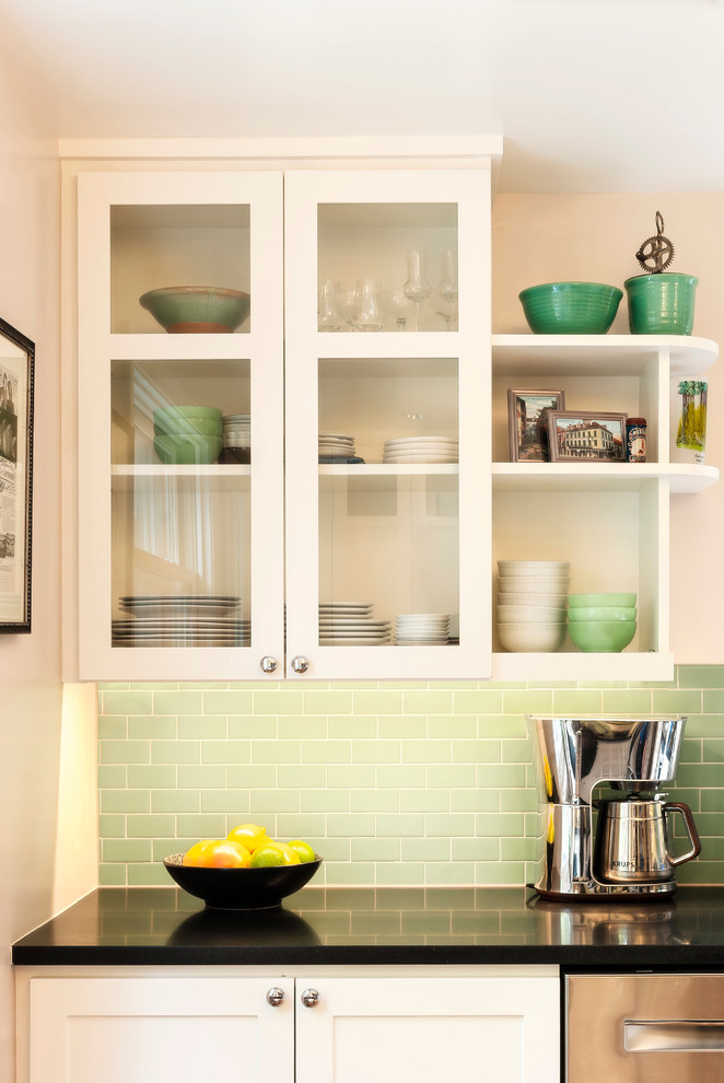 Inspiration for a small u-shaped enclosed kitchen remodel in Seattle with a farmhouse sink, shaker cabinets, white cabinets, green backsplash, porcelain backsplash, stainless steel appliances and no island