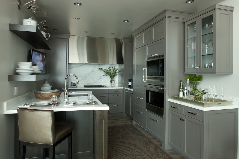 Inspiration for a contemporary kitchen remodel in Chicago with shaker cabinets, gray cabinets, paneled appliances, white backsplash and stone slab backsplash
