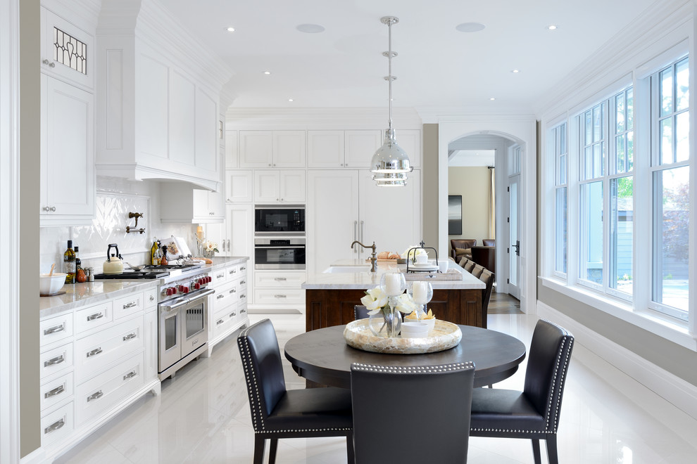 Inspiration for an expansive traditional l-shaped kitchen/diner in Toronto with a belfast sink, shaker cabinets, white cabinets, engineered stone countertops, white splashback, stainless steel appliances, porcelain flooring, an island and white floors.