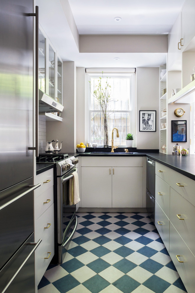 Inspiration for a small classic galley enclosed kitchen in New York with white cabinets, soapstone worktops, white splashback, porcelain splashback, stainless steel appliances, porcelain flooring, no island, blue floors, an integrated sink and flat-panel cabinets.