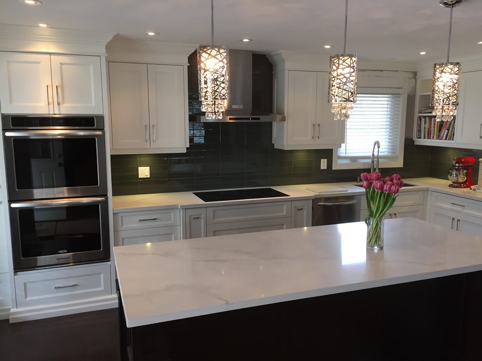 Medium sized traditional l-shaped open plan kitchen in Toronto with a submerged sink, white cabinets, quartz worktops, grey splashback, porcelain splashback, stainless steel appliances, dark hardwood flooring, an island, brown floors and recessed-panel cabinets.