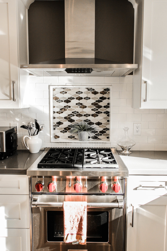 Inspiration for a large timeless u-shaped medium tone wood floor open concept kitchen remodel in San Francisco with an undermount sink, shaker cabinets, white cabinets, granite countertops, beige backsplash, mosaic tile backsplash, stainless steel appliances and an island