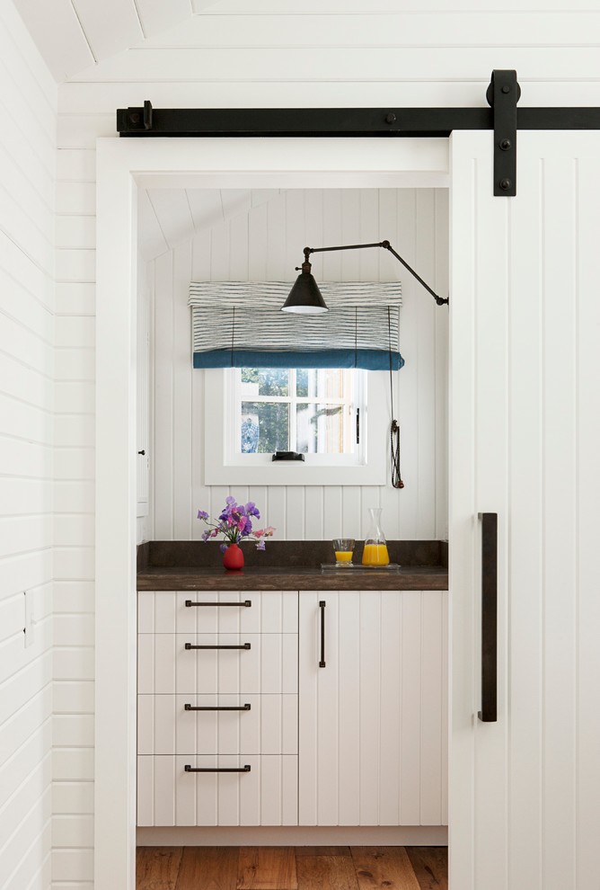 Kitchen - contemporary kitchen idea in San Francisco with white cabinets and wood countertops