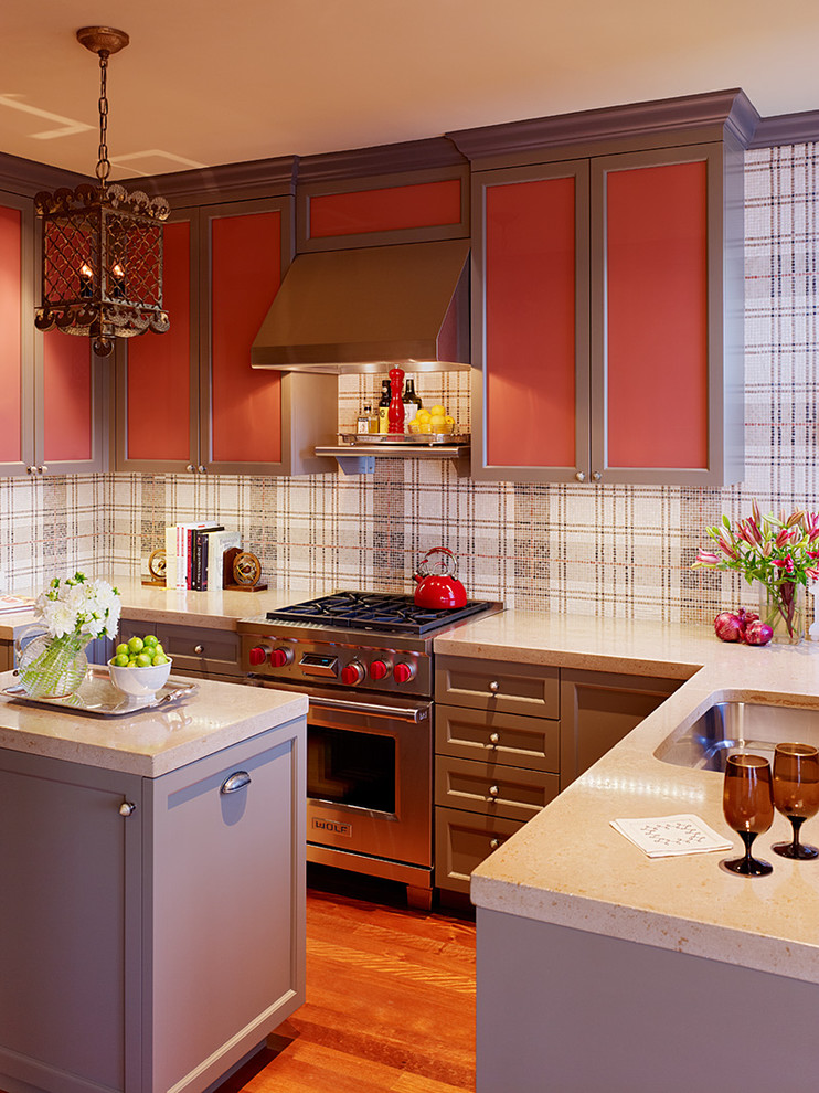Example of an eclectic kitchen design in San Francisco with recessed-panel cabinets, stainless steel appliances, an undermount sink, red cabinets, concrete countertops and multicolored backsplash