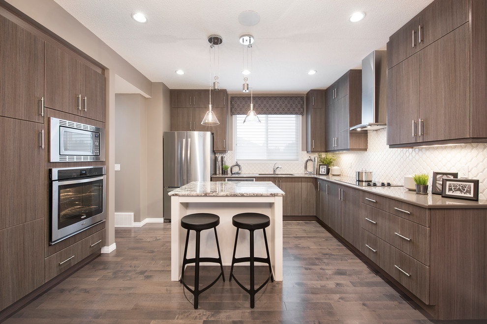 Inspiration for a mid-sized contemporary l-shaped dark wood floor open concept kitchen remodel in Edmonton with an undermount sink, flat-panel cabinets, blue cabinets, quartz countertops, white backsplash, porcelain backsplash, stainless steel appliances and an island