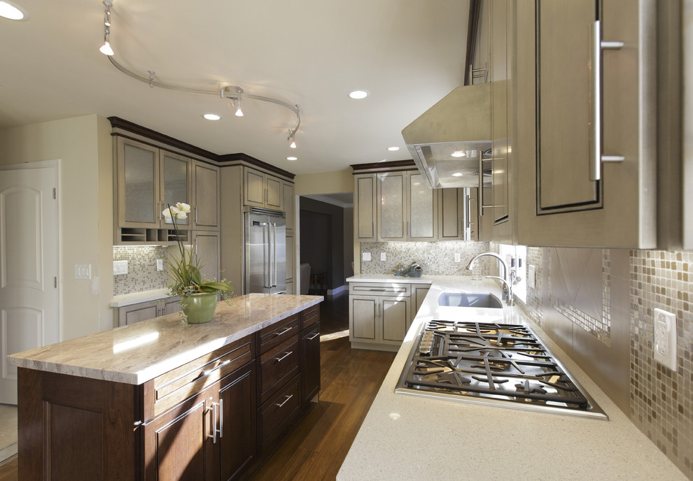 Example of a mid-sized transitional l-shaped medium tone wood floor and brown floor eat-in kitchen design in San Francisco with stainless steel appliances, quartz countertops, an undermount sink, beige backsplash, raised-panel cabinets, light wood cabinets, an island, mosaic tile backsplash and beige countertops