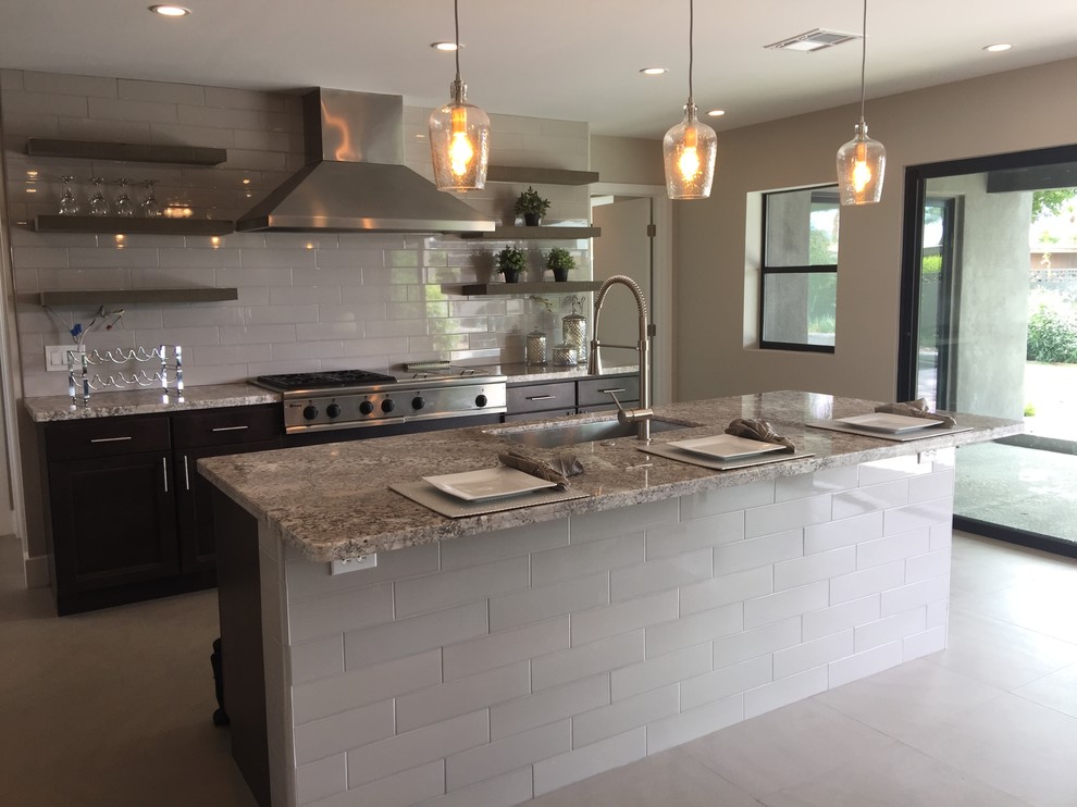 Inspiration for a mid-sized contemporary galley ceramic tile open concept kitchen remodel in Phoenix with an undermount sink, flat-panel cabinets, dark wood cabinets, granite countertops, gray backsplash, subway tile backsplash, stainless steel appliances and an island