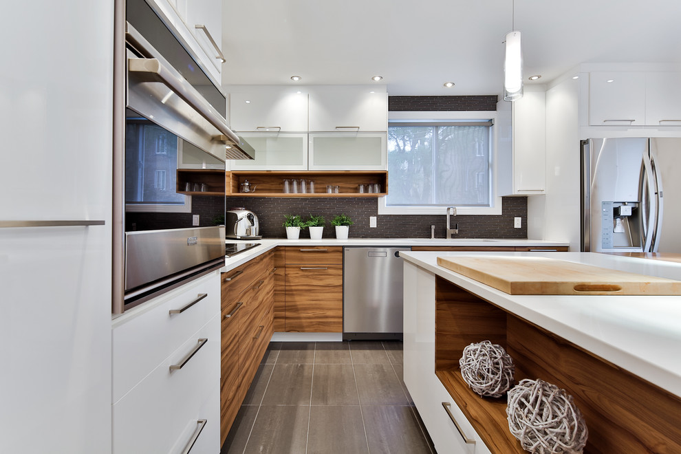 Moderne Küche in L-Form mit Unterbauwaschbecken, flächenbündigen Schrankfronten, hellbraunen Holzschränken, Küchenrückwand in Schwarz, Rückwand aus Stäbchenfliesen, Küchengeräten aus Edelstahl und Kücheninsel in Montreal