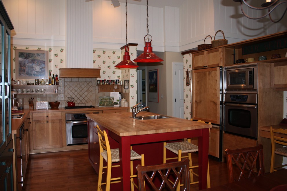 Example of a mid-sized arts and crafts u-shaped medium tone wood floor and brown floor eat-in kitchen design in Grand Rapids with recessed-panel cabinets, light wood cabinets, wood countertops, an island, a drop-in sink, beige backsplash, terra-cotta backsplash and paneled appliances