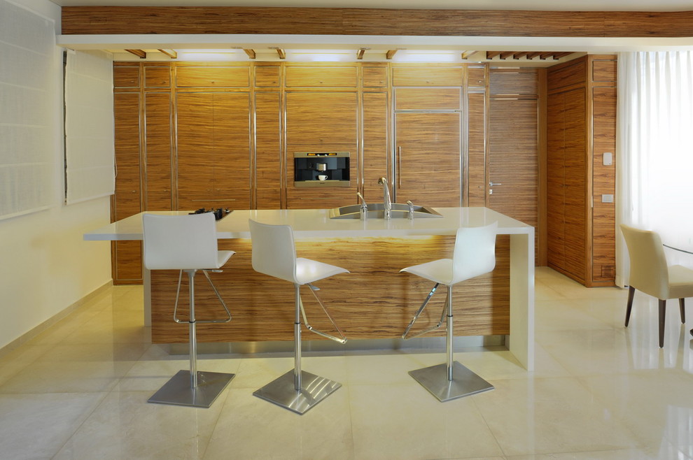 На фото: параллельная кухня в стиле модернизм с обеденным столом, накладной мойкой, плоскими фасадами, фасадами цвета дерева среднего тона и техникой под мебельный фасад с