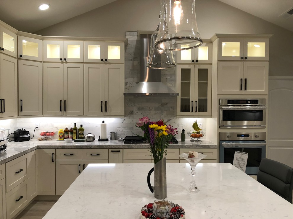 This is an example of a large modern u-shaped kitchen/diner in San Francisco with a submerged sink, shaker cabinets, white cabinets, wood worktops, multi-coloured splashback, metro tiled splashback, stainless steel appliances, porcelain flooring, an island, grey floors and white worktops.