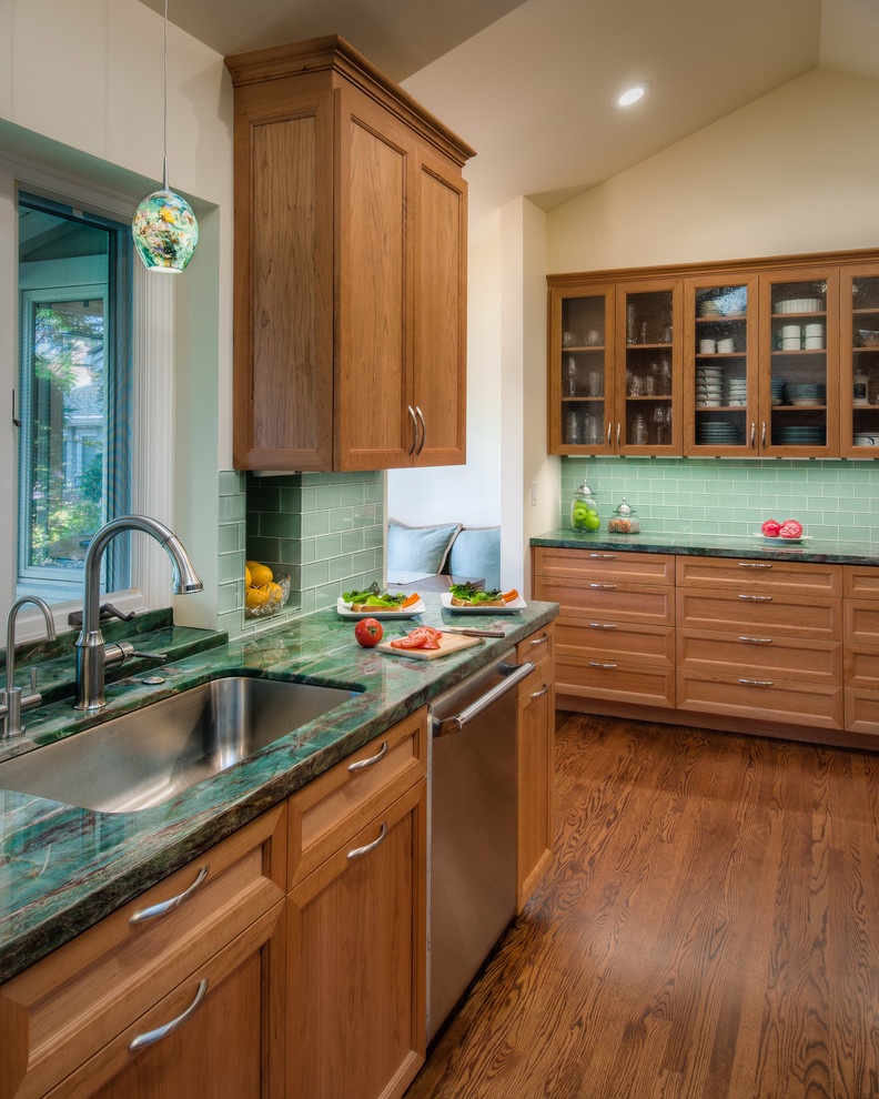 Inspiration for a mid-sized transitional galley medium tone wood floor eat-in kitchen remodel in San Francisco with an undermount sink, recessed-panel cabinets, medium tone wood cabinets, quartzite countertops, green backsplash, glass tile backsplash, stainless steel appliances and no island