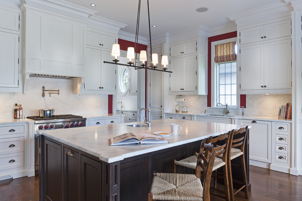 Example of a large classic u-shaped dark wood floor eat-in kitchen design in Toronto with a double-bowl sink, recessed-panel cabinets, white cabinets, marble countertops, white backsplash, glass tile backsplash, stainless steel appliances and an island