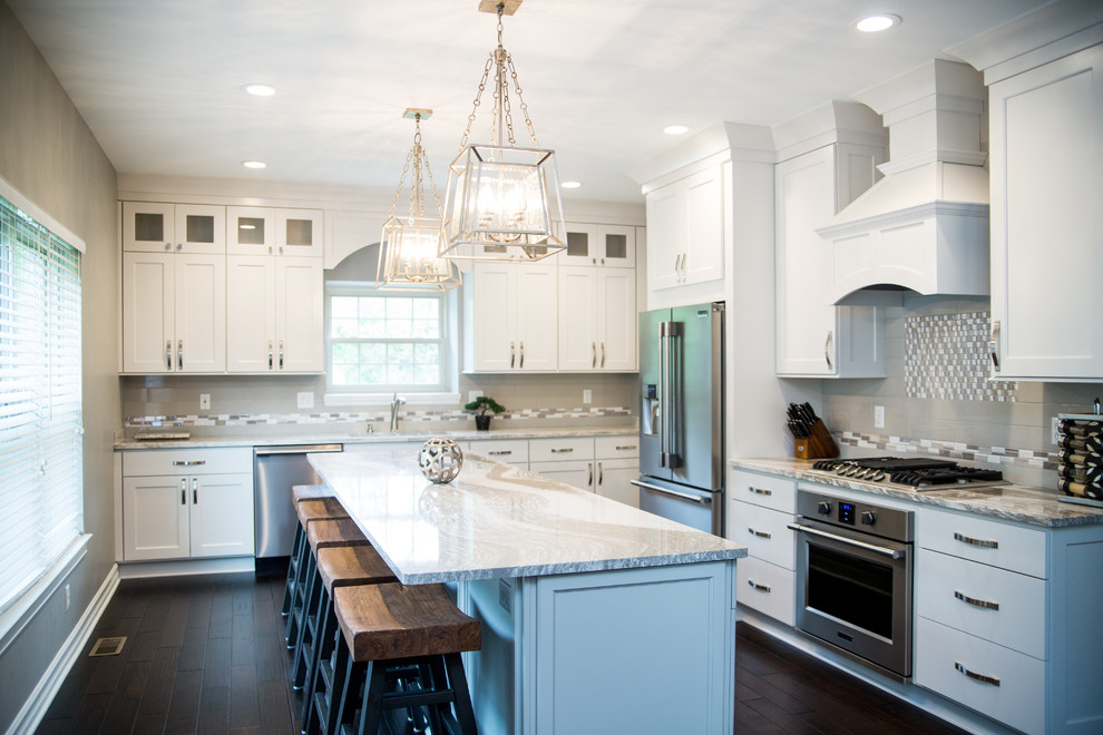 Geschlossene Klassische Küche in L-Form mit Schrankfronten im Shaker-Stil, blauen Schränken, Küchenrückwand in Grau, Küchengeräten aus Edelstahl, Kücheninsel und dunklem Holzboden in Detroit